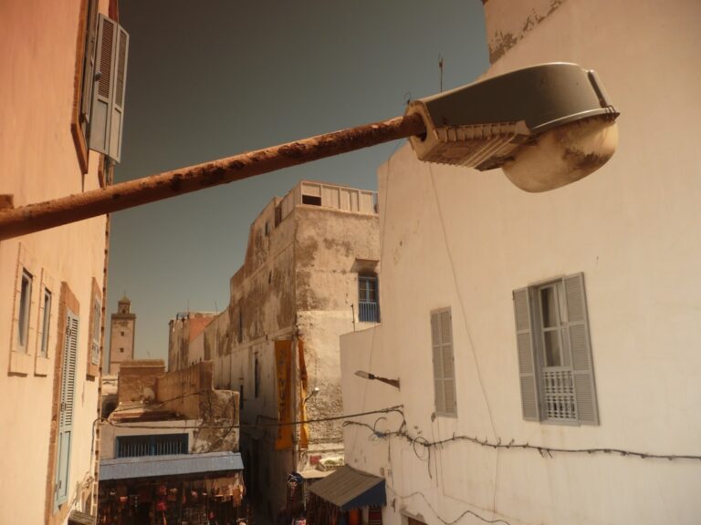 black street light near white concrete building during daytime