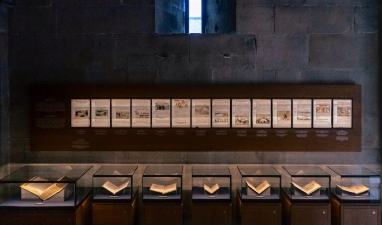 A row of books sitting on top of a wooden shelf