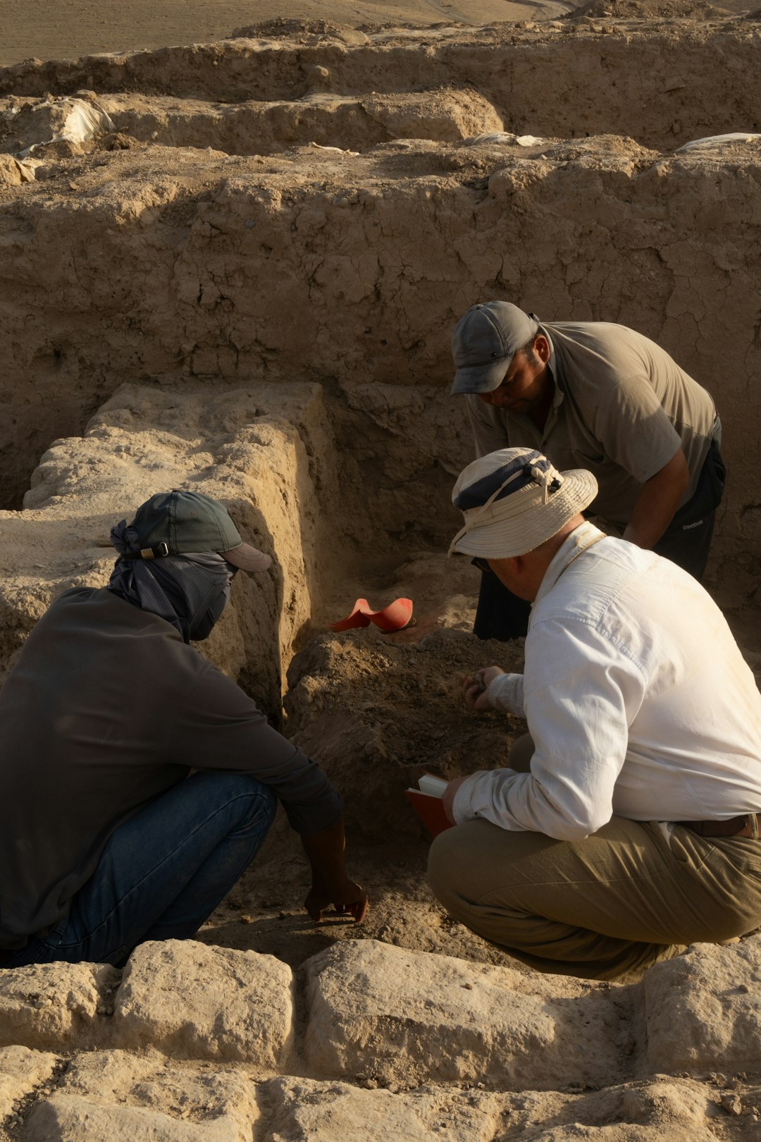 A group of men kneeling down next to each other