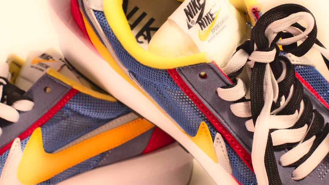 A pair of blue and yellow sneakers on a white surface